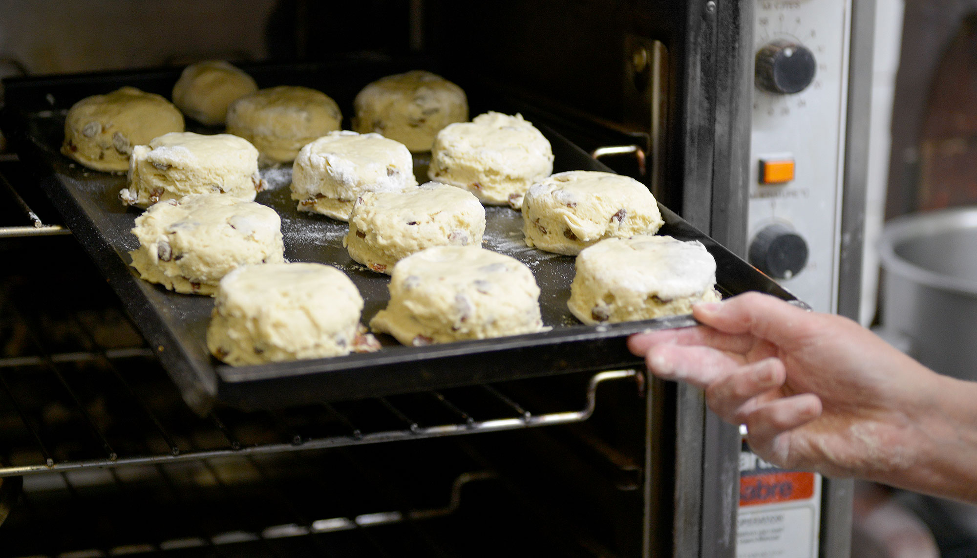 Fresh scones being taken from the oven